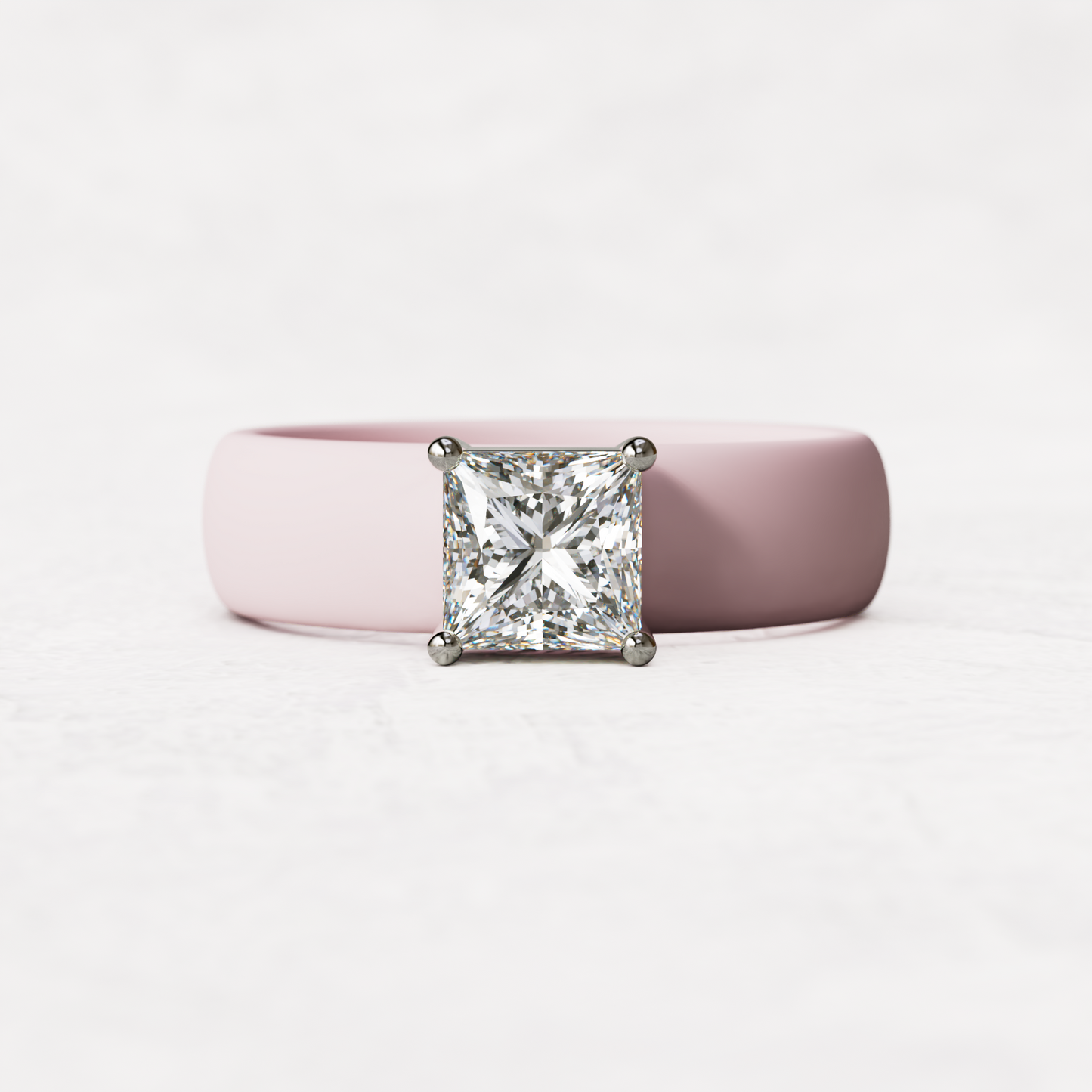 Pink silicone ring with a one carat princess cut diamond set in 14 karat white Gold