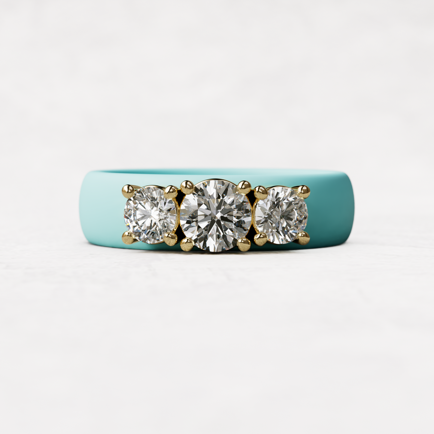 Three stone aqua silicone diamond ring with one half carat round diamond and two quarter carat round diamonds set in 14 karat gold