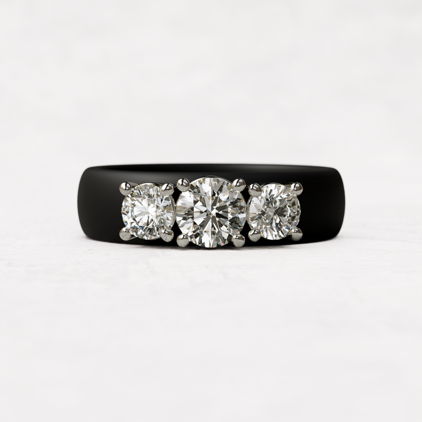 Three stone black silicone diamond ring with one half carat round diamond and two quarter carat round diamonds set in 14 karat white gold