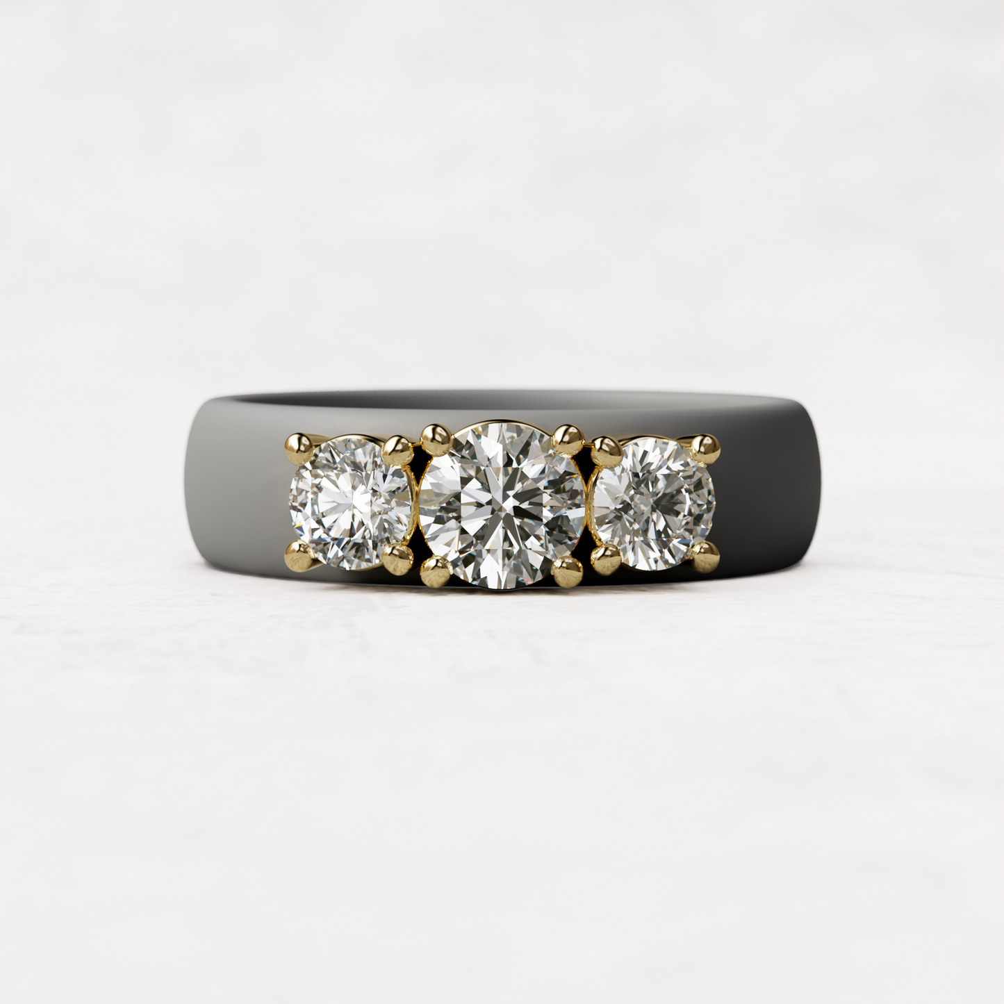Three stone gray silicone diamond ring with one half carat round diamond and two quarter carat round diamonds set in 14 karat gold