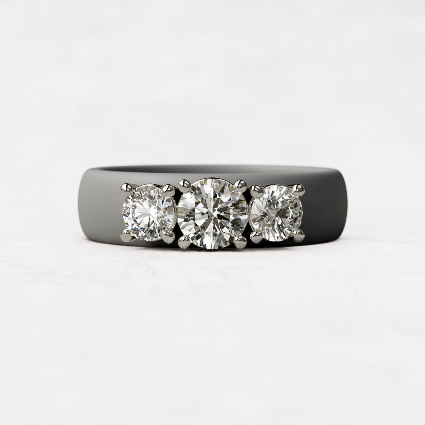 Three stone gray silicone diamond ring with one half carat round diamond and two quarter carat round diamonds set in 14 karat white gold