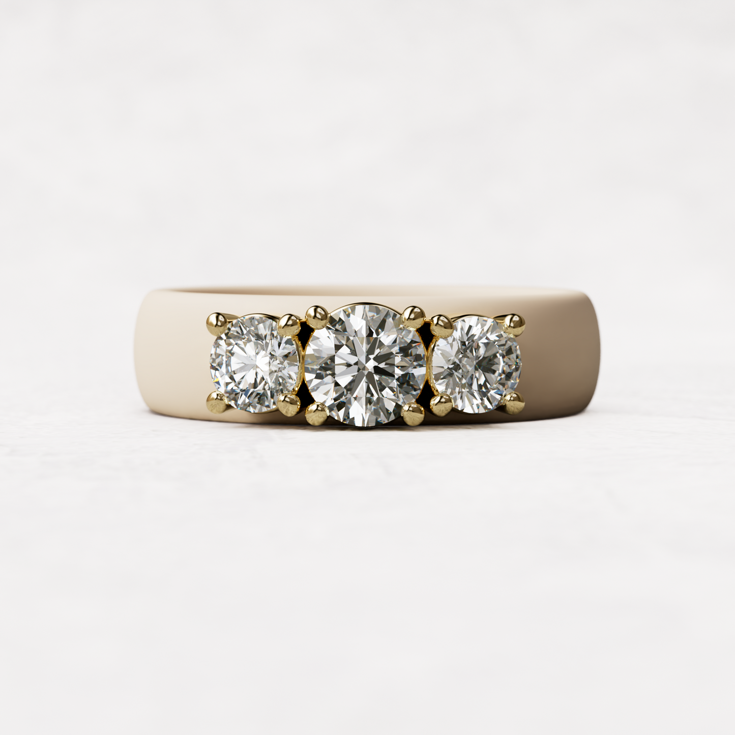 Three stone nude silicone diamond ring with one half carat round diamond and two quarter carat round diamonds set in 14 karat gold