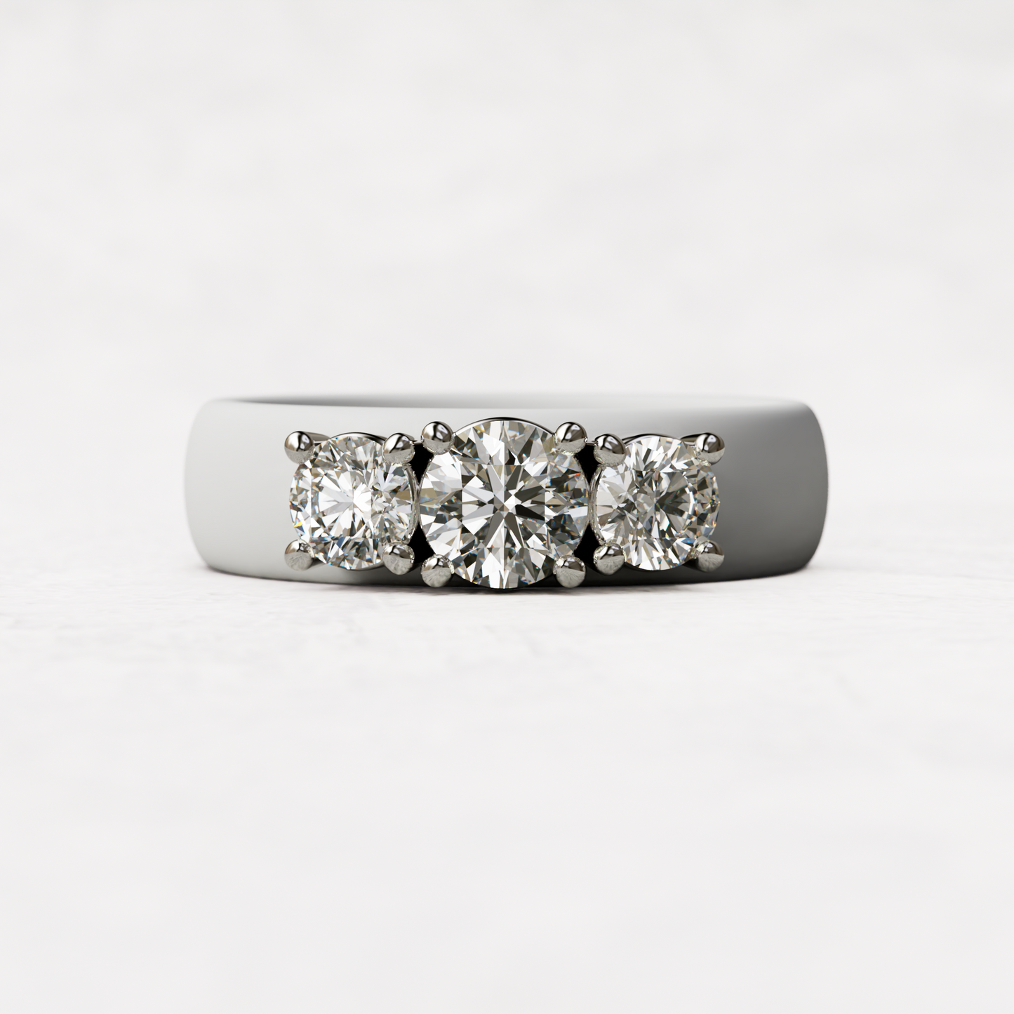 Three stone white silicone diamond ring with one half carat round diamond and two quarter carat round diamonds set in 14 karat white gold