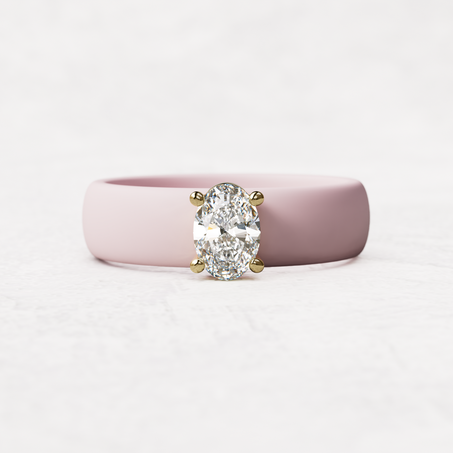 Pink silicone ring with a half carat oval diamond set in 14 karat Gold
