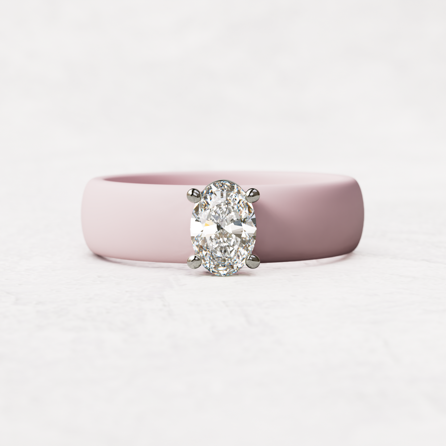 Pink silicone ring with a half carat oval diamond set in 14 karat white Gold