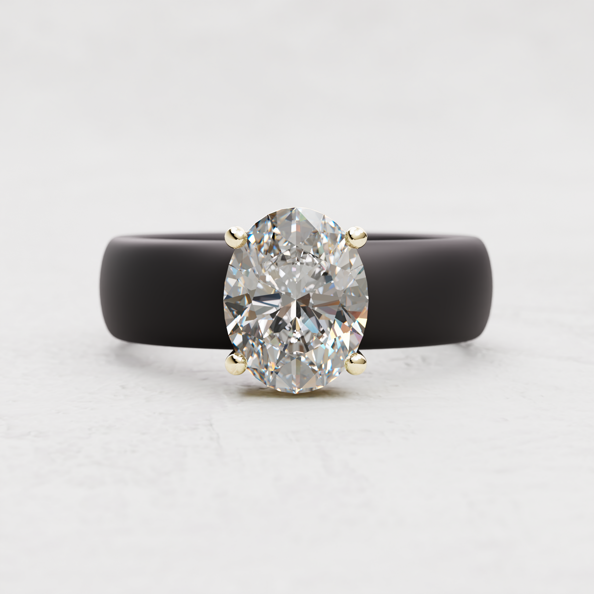An oval-cut diamond ring with a matte black band and yellow gold prongs, centered on a light gray background.