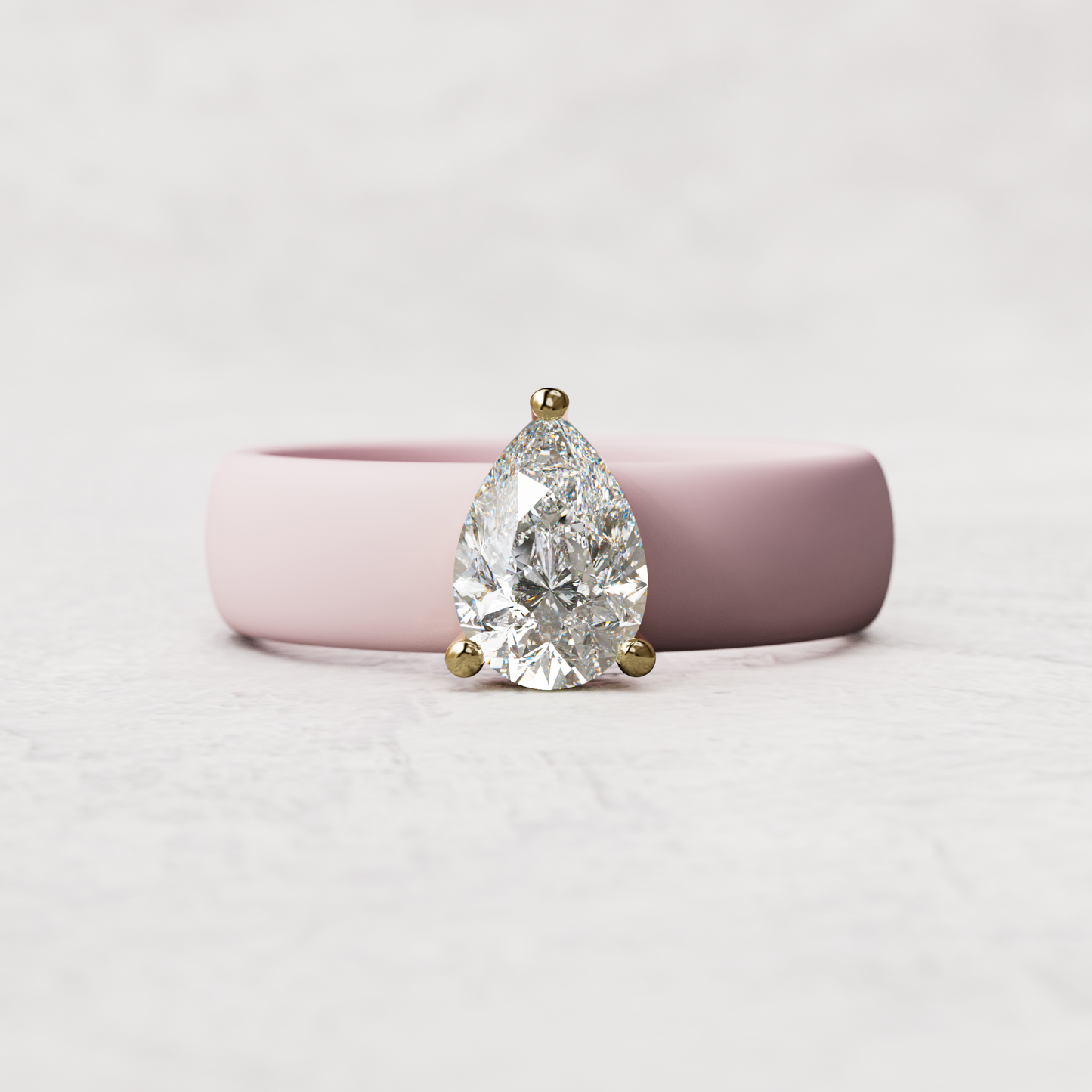 Pink silicone band with 1 carat pear diamond set in 14 karat Gold