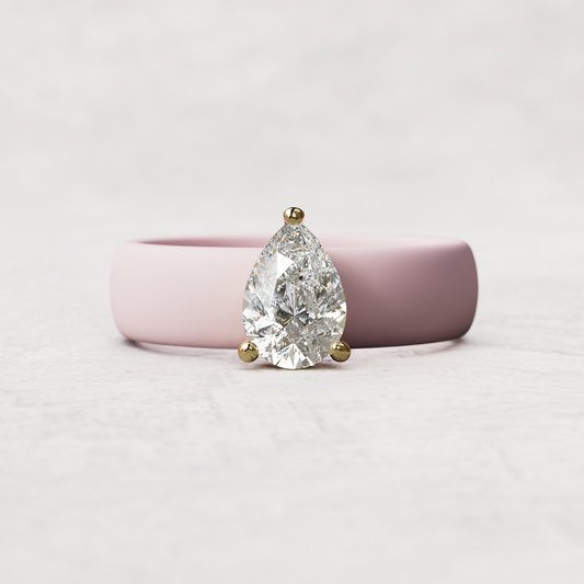 Pink silicone band with 1 carat pear diamond set in 14 karat Gold