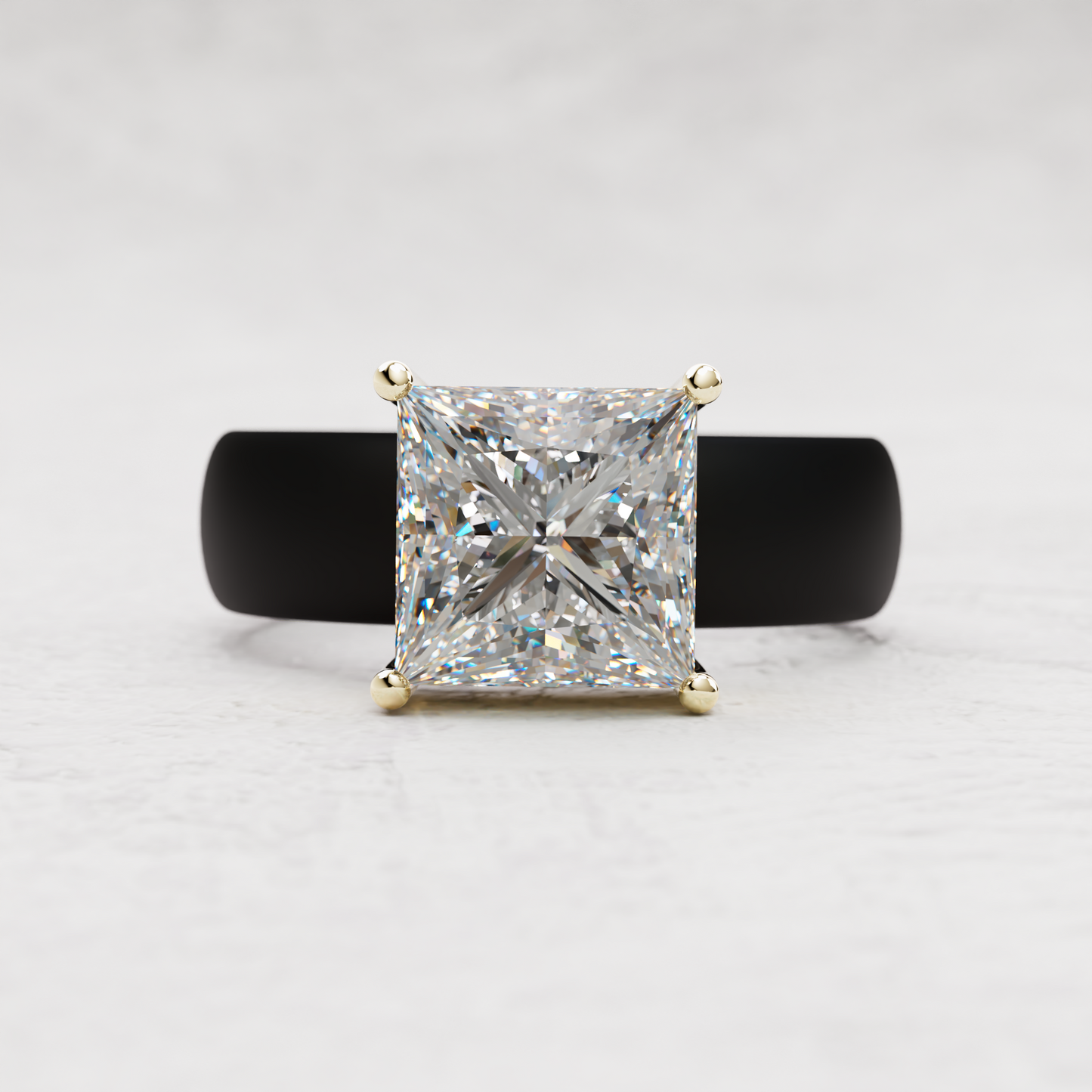 A princess-cut diamond ring with a yellow gold four-prong setting, displayed on a black ring stand against a light gray textured background.