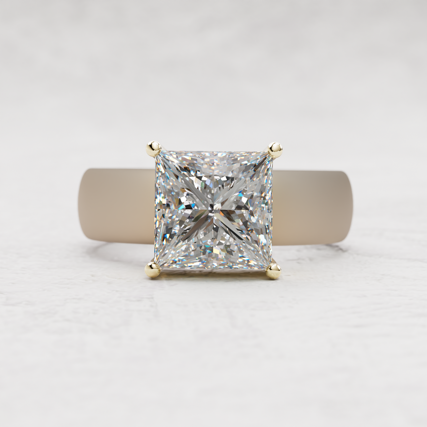 A princess-cut diamond ring in a yellow gold four-prong setting, displayed on a neutral cylindrical stand against a light gray textured background.