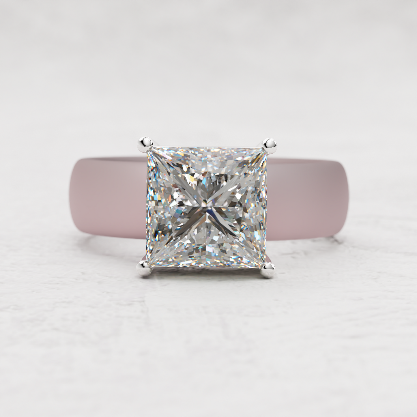 A princess-cut diamond ring with a silver-toned band, centered against a soft pink background on a light gray textured surface.