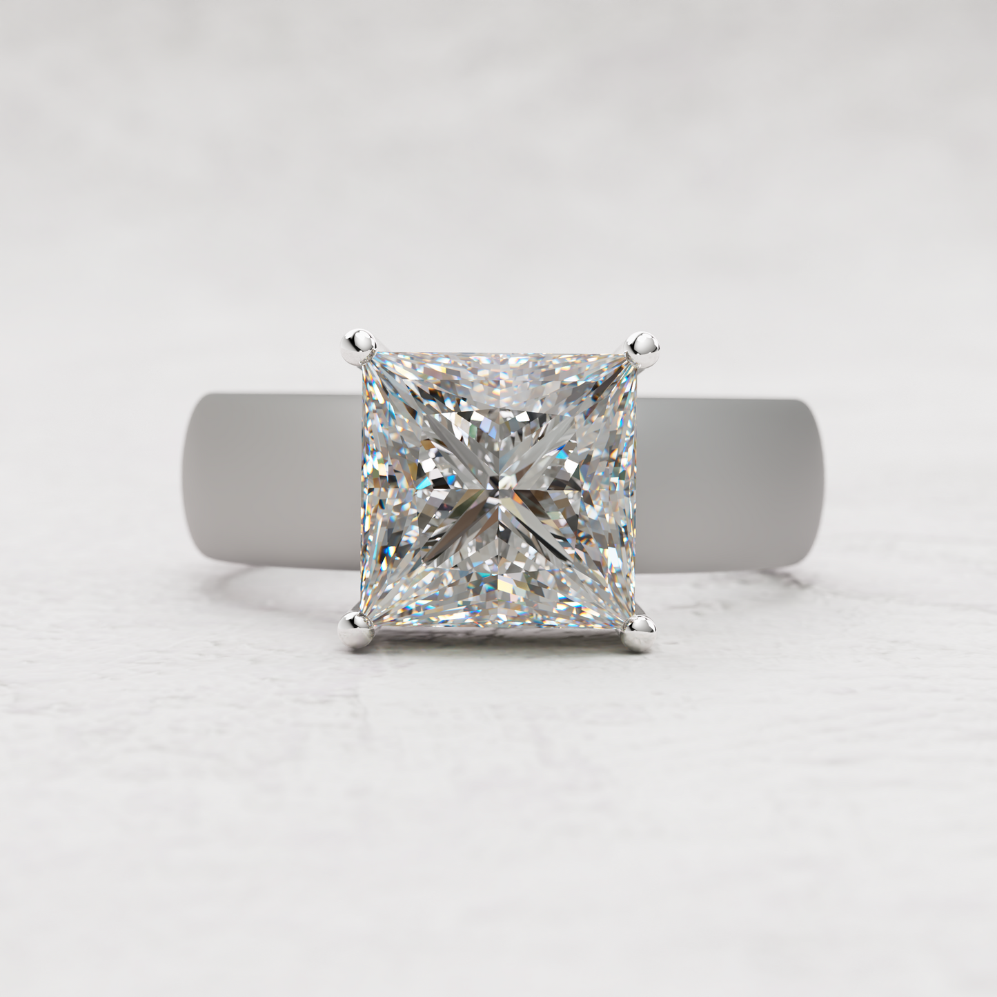 A princess-cut diamond ring with a silver-toned band, centered on a light gray textured background.