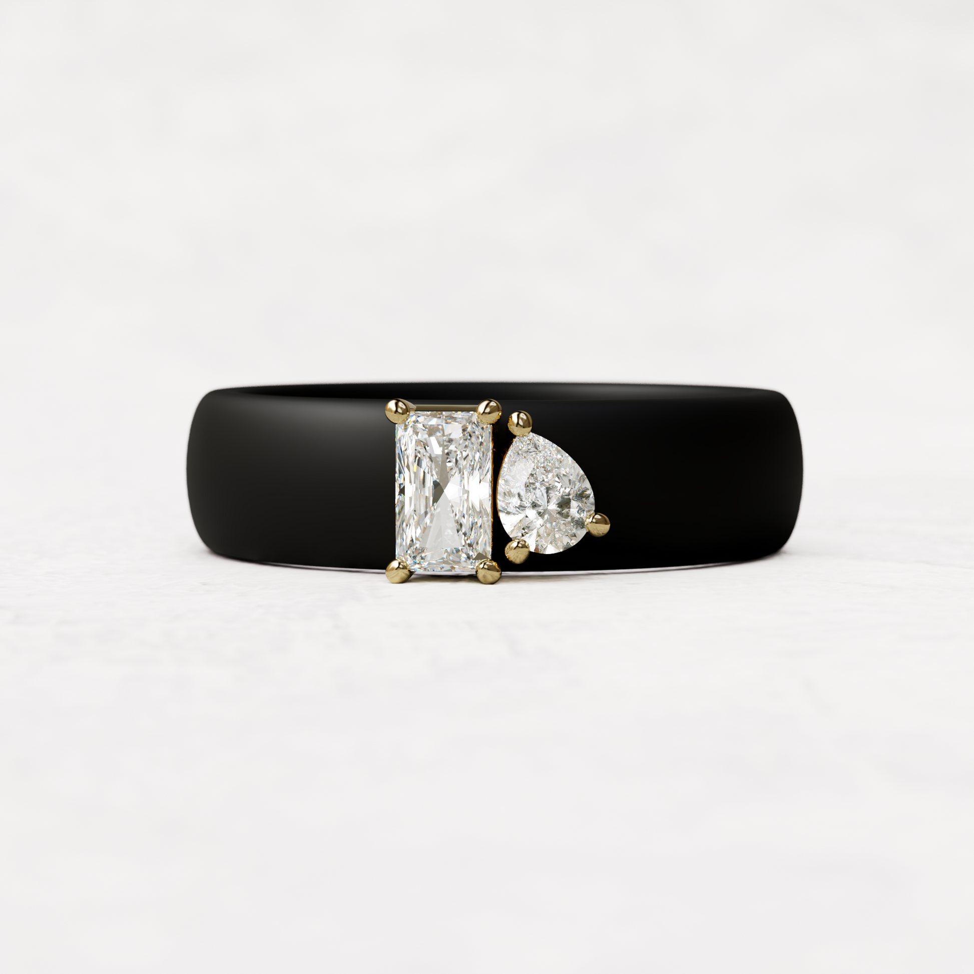 Black silicone diamond toi et moi ring with one radiant diamond and one pear cut diamond set in 14 karat Gold 