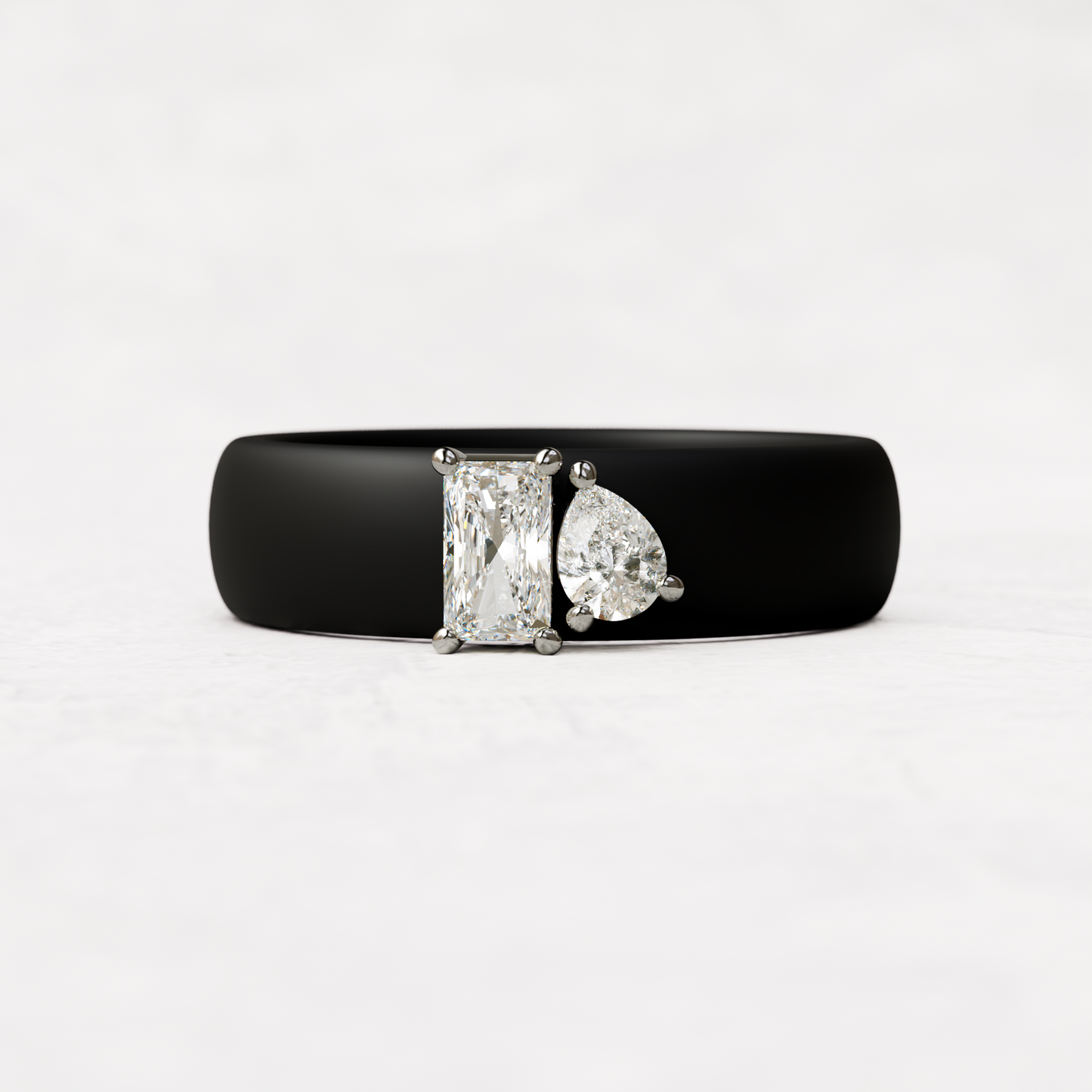 Black silicone diamond toi et moi ring with one radiant diamond and one pear cut diamond set in 14 karat white Gold 