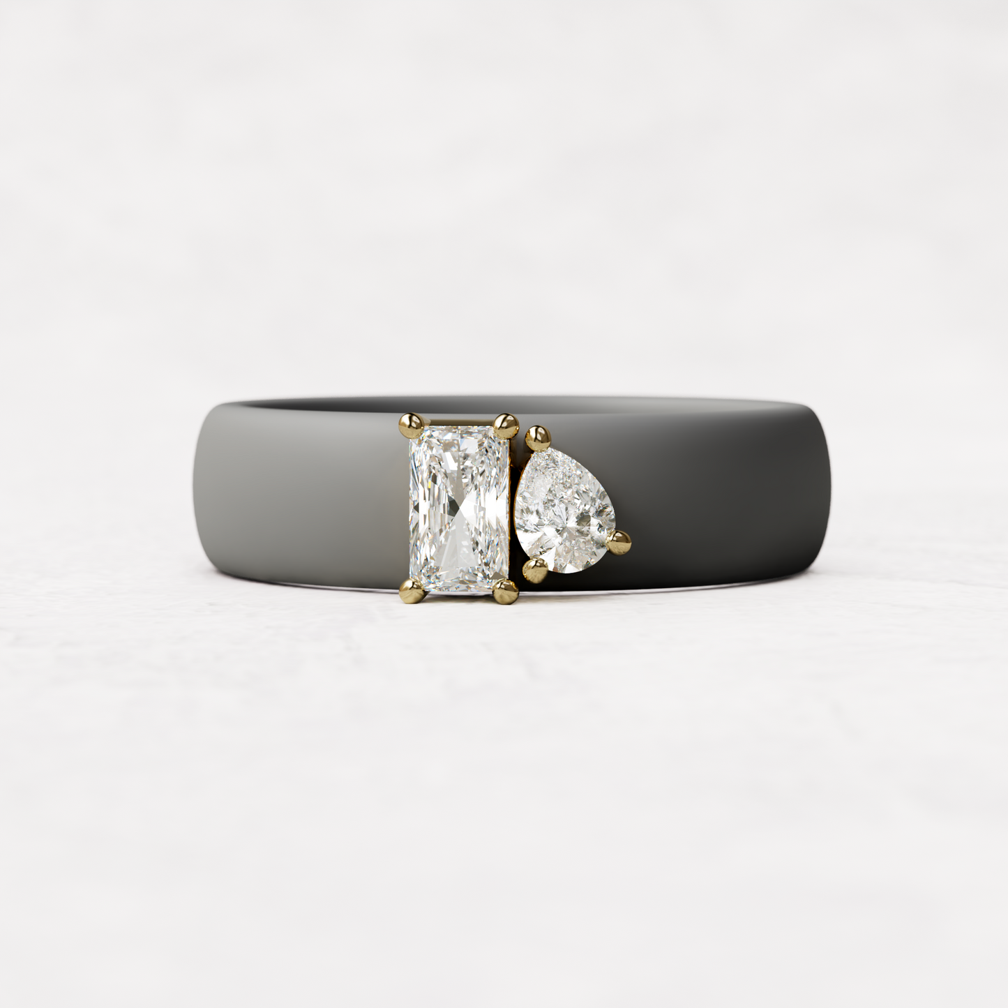 Gray silicone diamond toi et moi ring with one radiant diamond and one pear cut diamond set in 14 karat Gold 