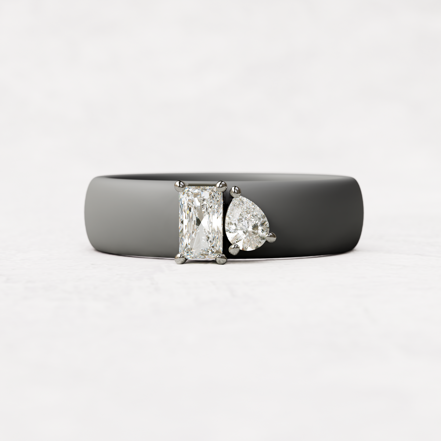 Gray silicone diamond toi et moi ring with one radiant diamond and one pear cut diamond set in 14 karat white Gold 