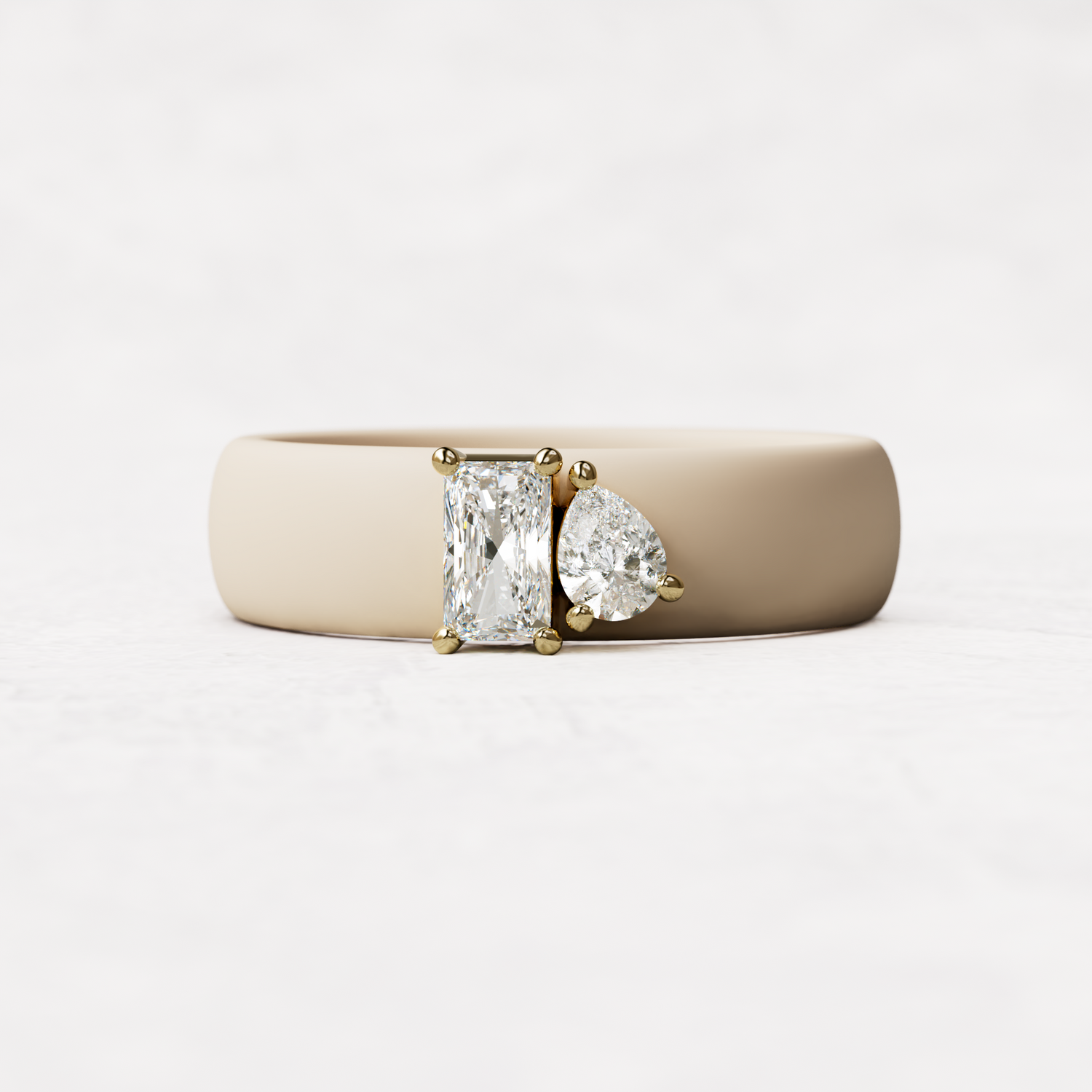 Nude silicone diamond toi et moi ring with one radiant diamond and one pear cut diamond set in 14 karat Gold 