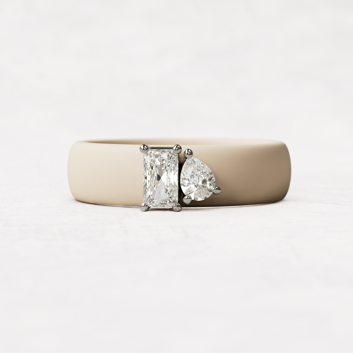 Nude silicone diamond toi et moi ring with one radiant diamond and one pear cut diamond set in 14 karat white Gold 