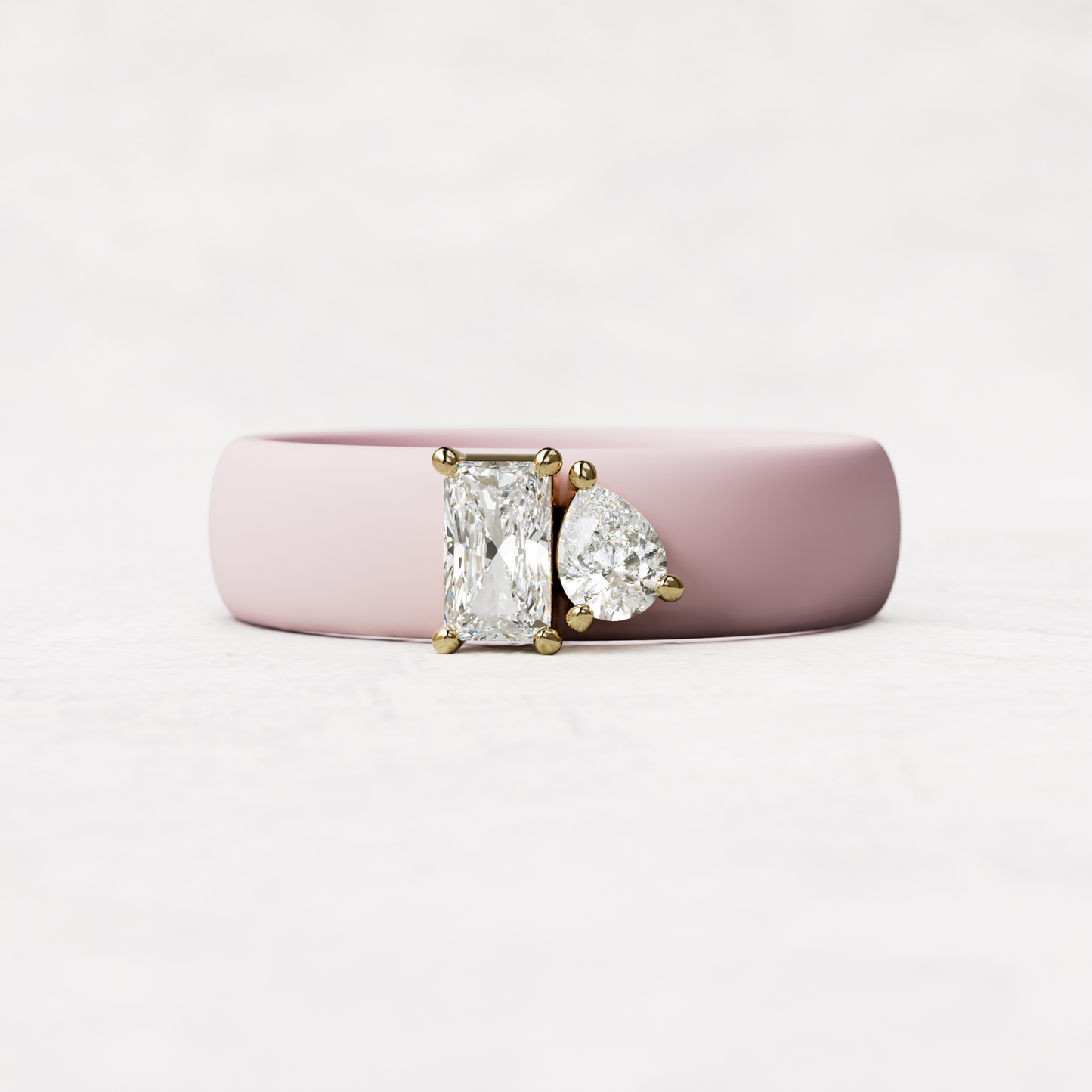 Pink silicone diamond toi et moi ring with one radiant diamonds and one pear cut diamond set in 14 karat Gold 