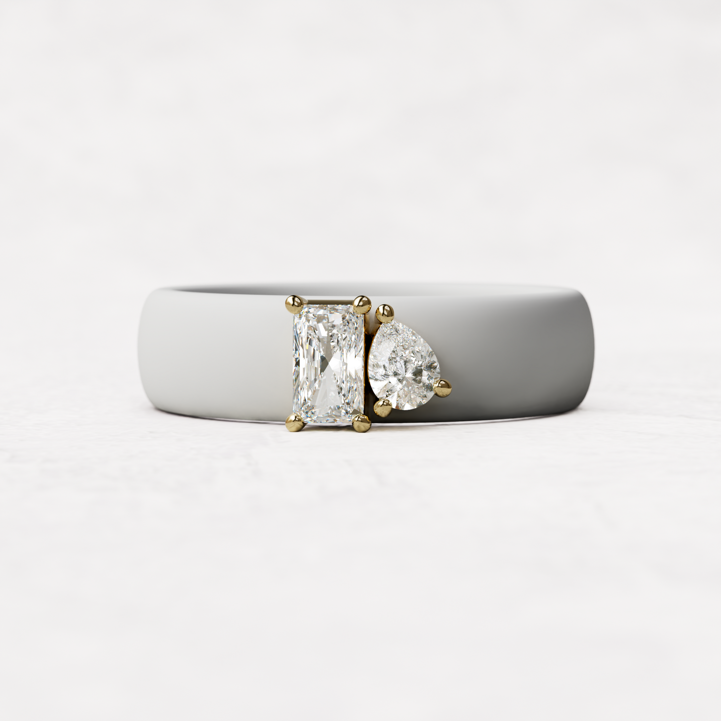 White silicone diamond toi et moi ring with one radiant diamond and one pear cut diamond set in 14 karat Gold 